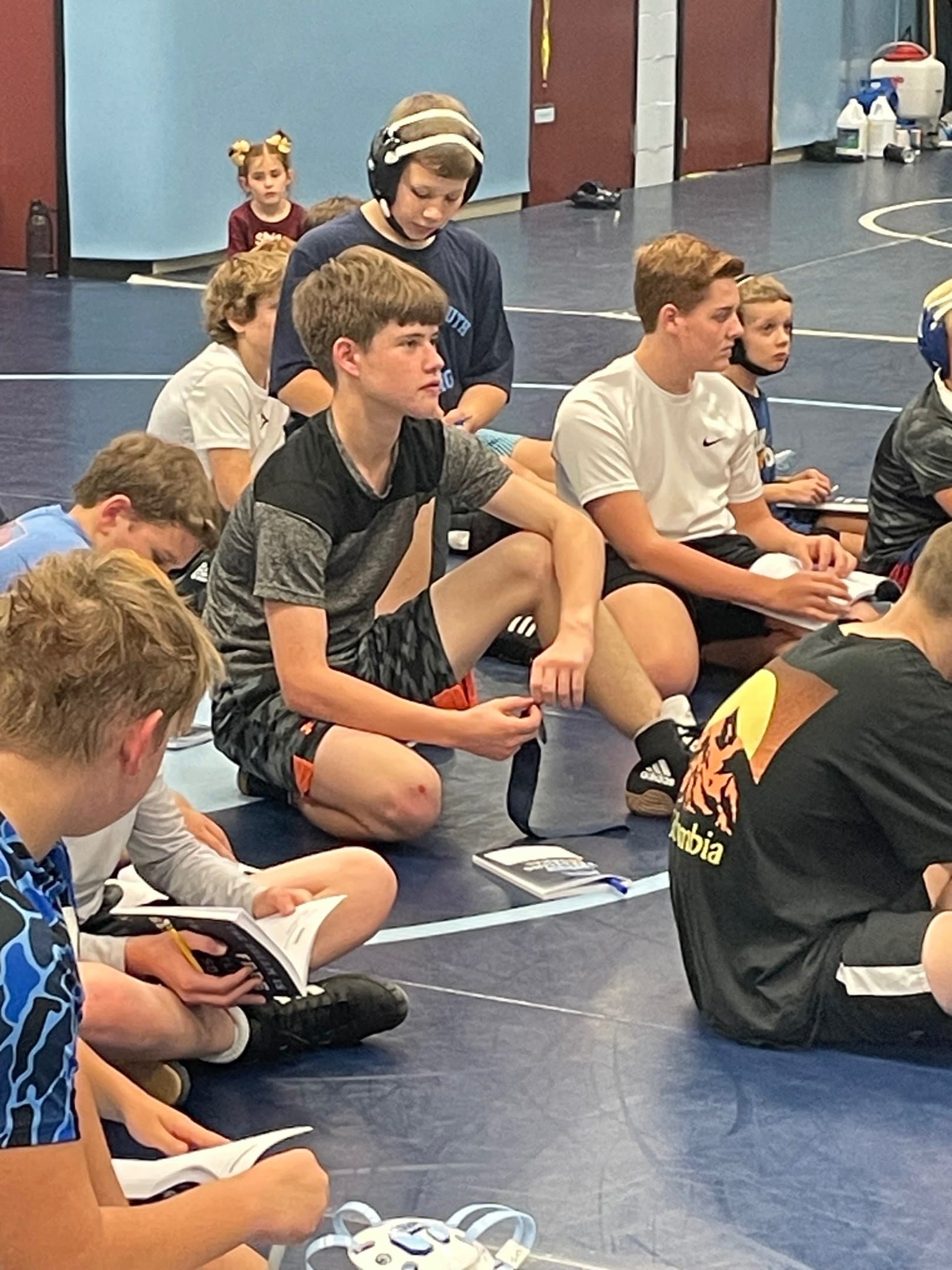 Wrestlers using journals in the room